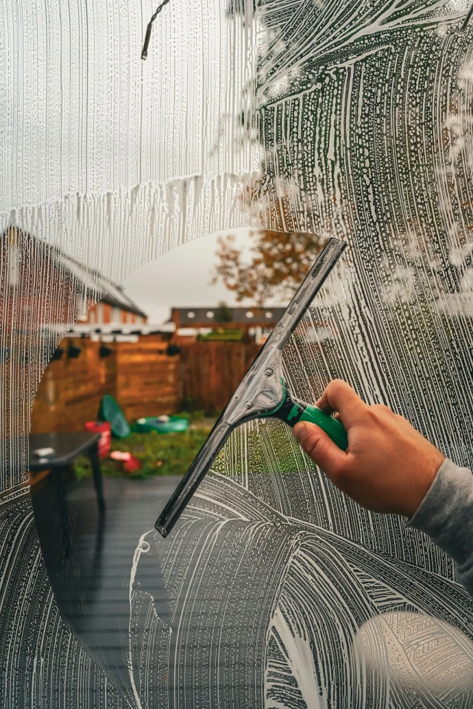 A person is drawing a picture on a window